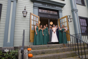 Bride with her bridesmaids and Moms at District Hall front door