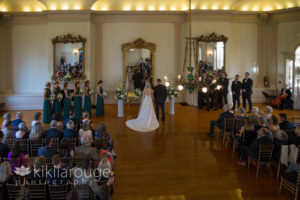 View of wedding in ballroom below from balcony
