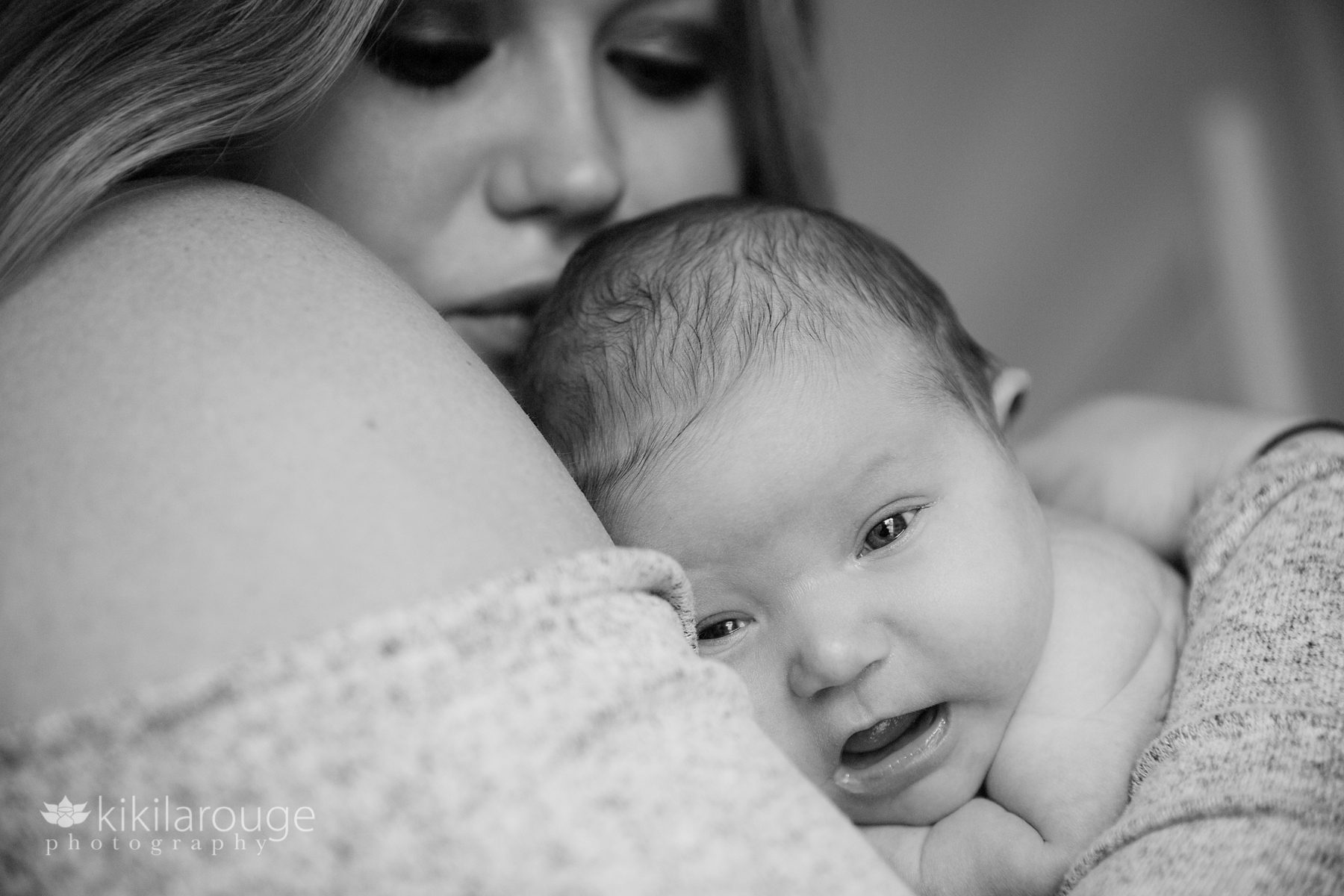 Newborn baby closeup in Mom's arms