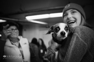 Girl with hat laughing with chihuahua rescue dog