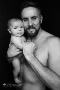Shirtless father with little nake baby girl