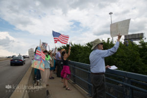 Group of protestors in overpass at Boston ICE Center