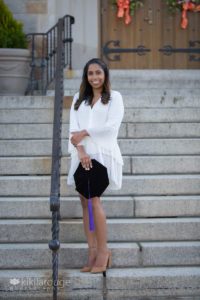 Woman with graduation cap with purple tassel in steps