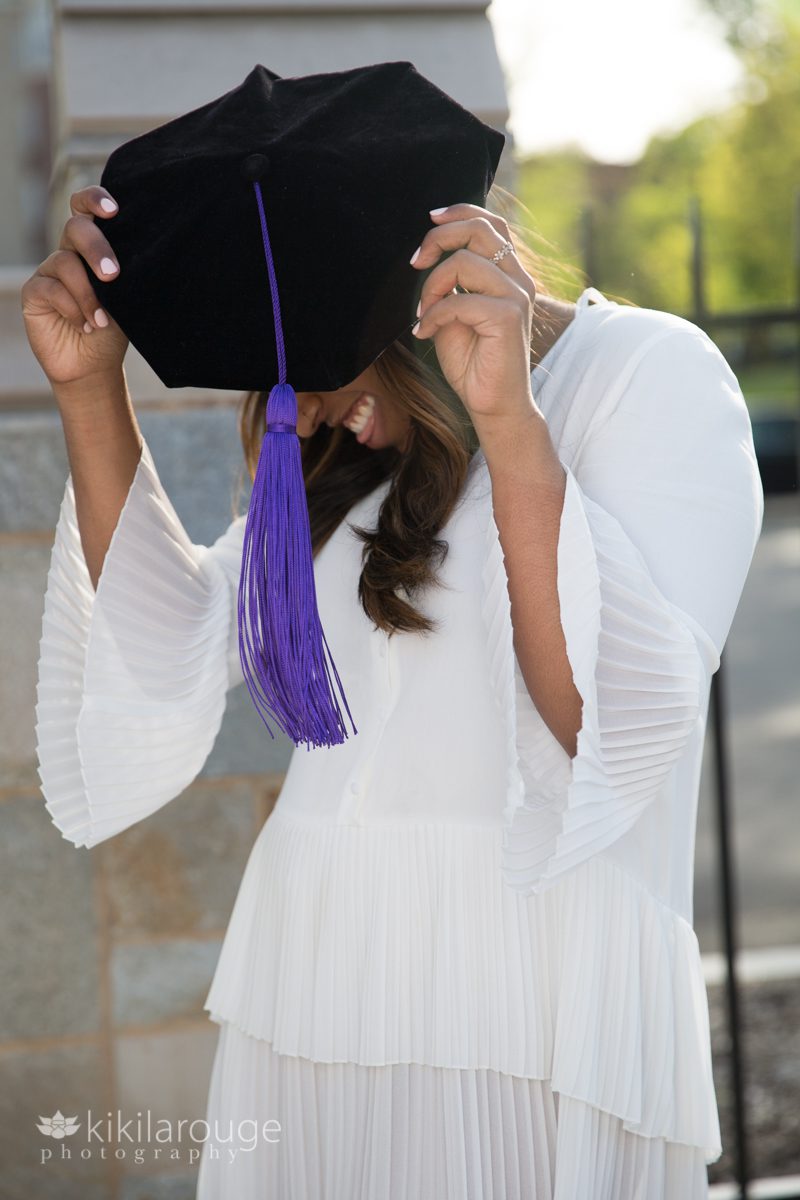 Woman with graduation cap with purple tassel in steps