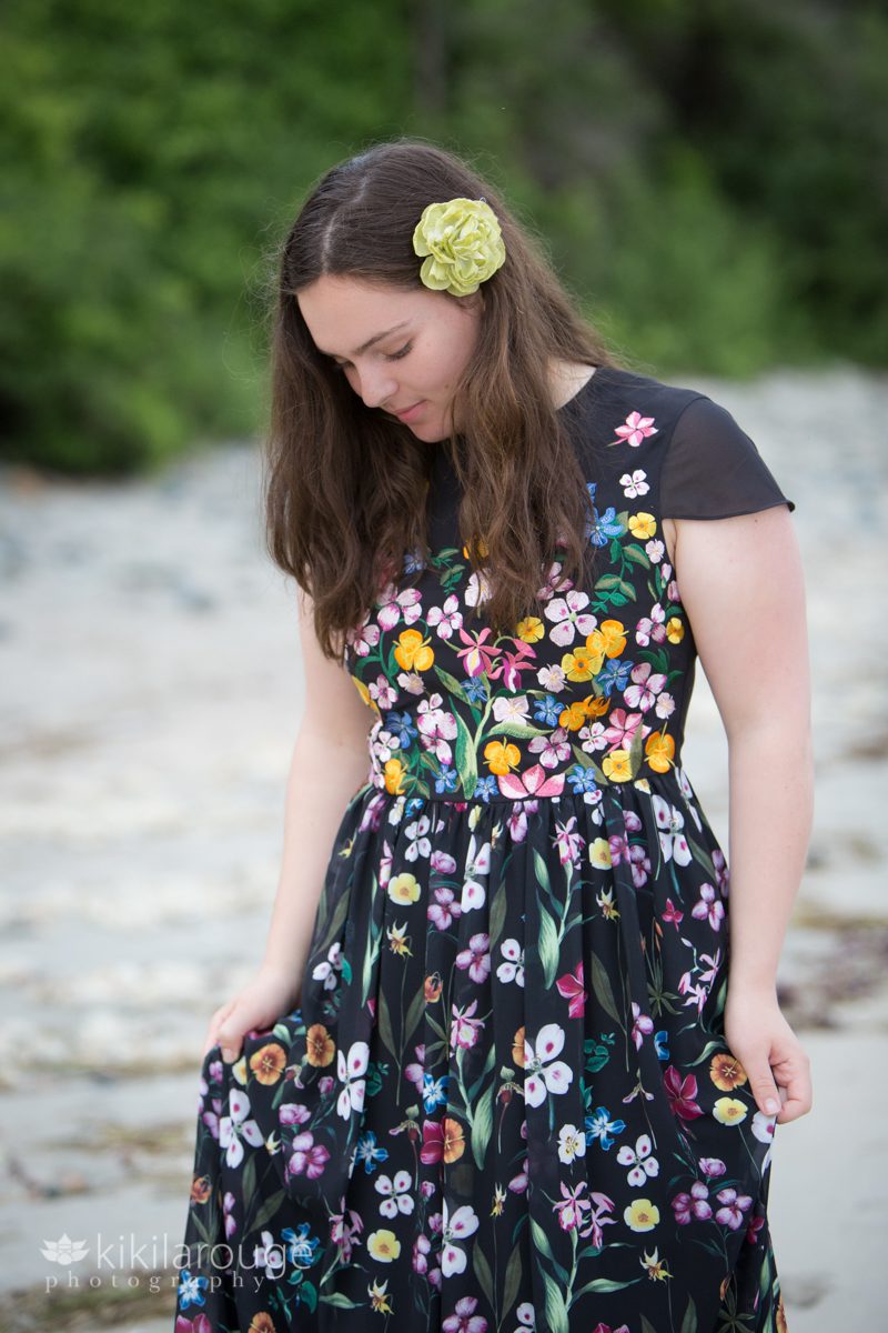 Senior girl with green flower in her hair and floral dress