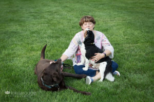 Mom with her two rescue dogs in grass