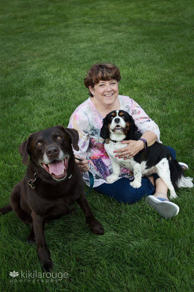 Mom with her two rescue dogs in grass