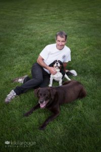Dad with his two rescue dogs in grass