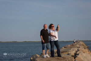 Popping champagne on breakwater to celebrate wedding proposal