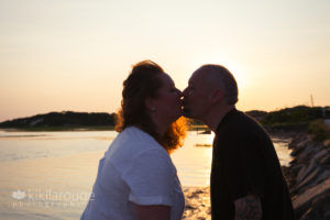 Couple silhouette kissing at sunset