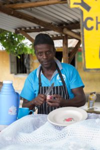 Ugandan man making rolex for customers