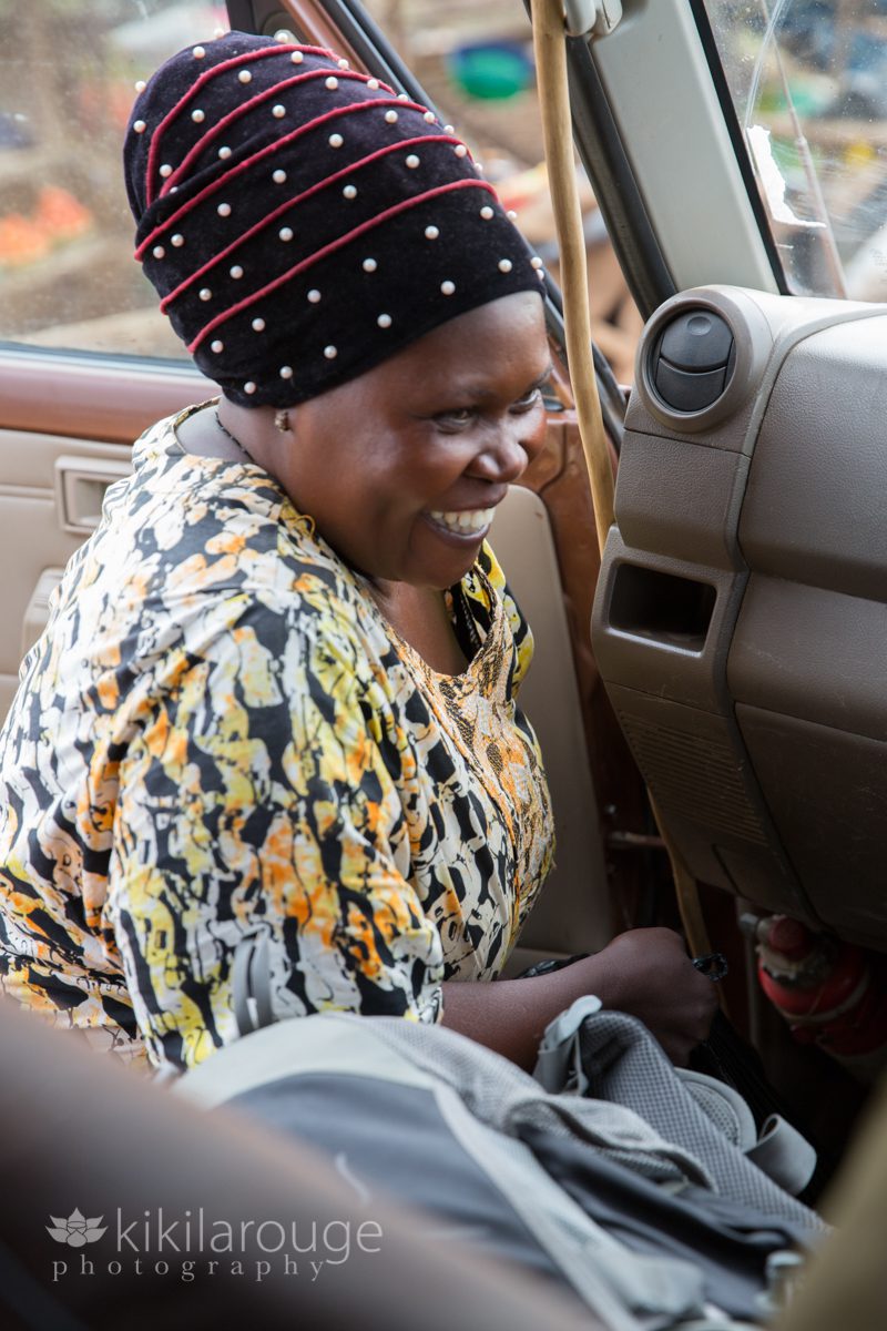 Uganda woman in African print dress selling goods at roadside