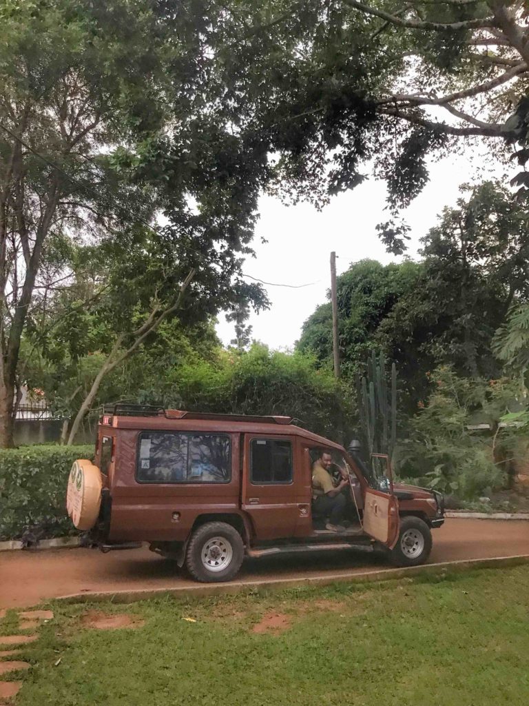 Ugandan tour guide in Safari vehicle 