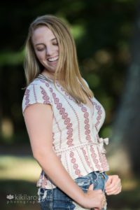 Blonde haired girl looking down laughing