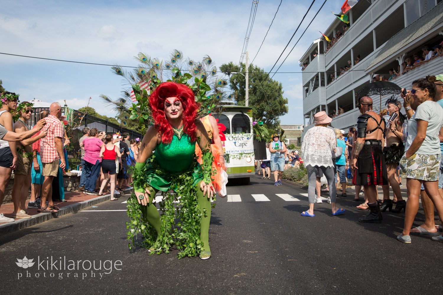 Drag queen with red hair and Peacock feathers