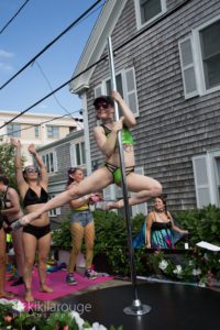 Girl in green pole dancing in carnival parade