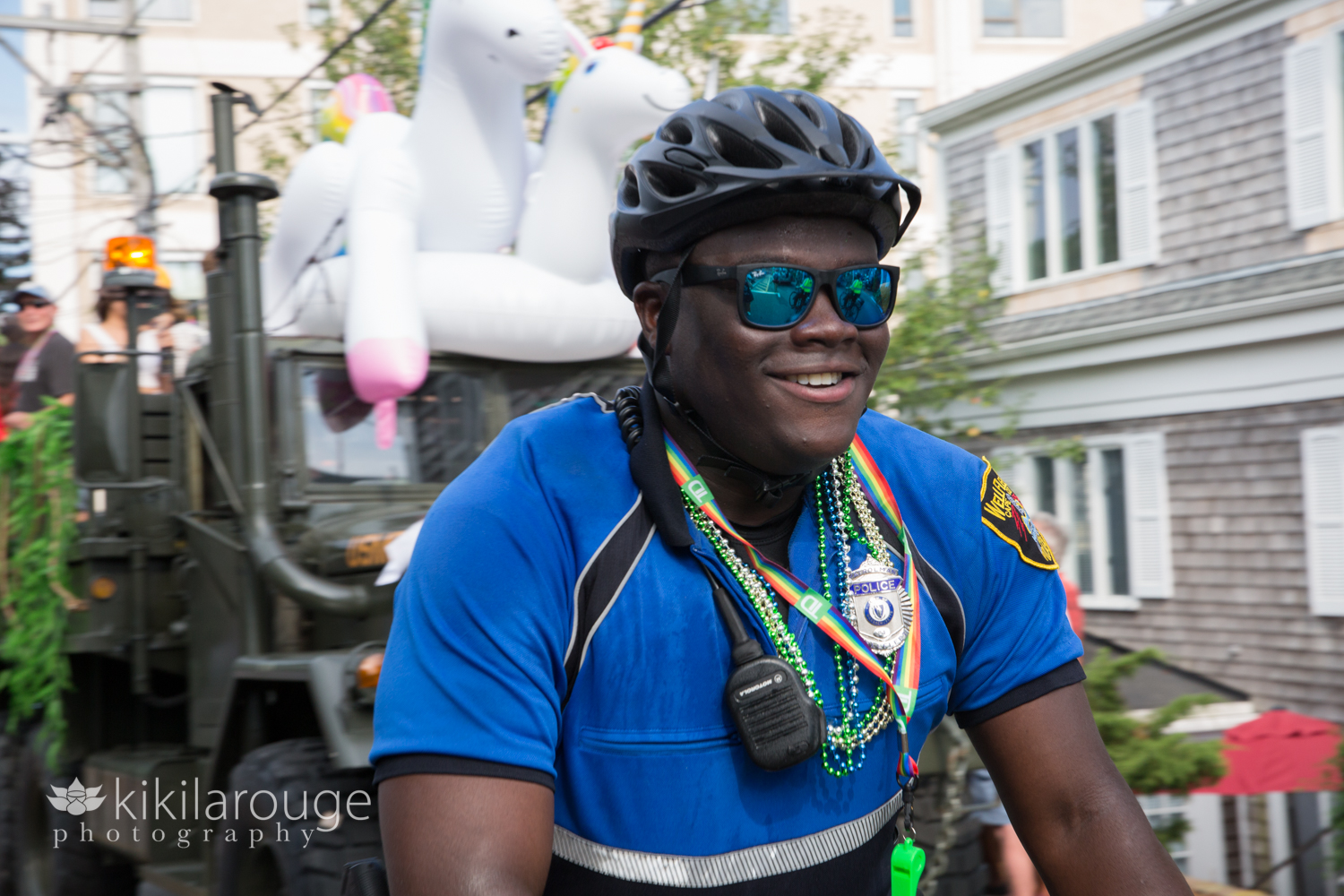 Police officer with carnival beads on bike at parade