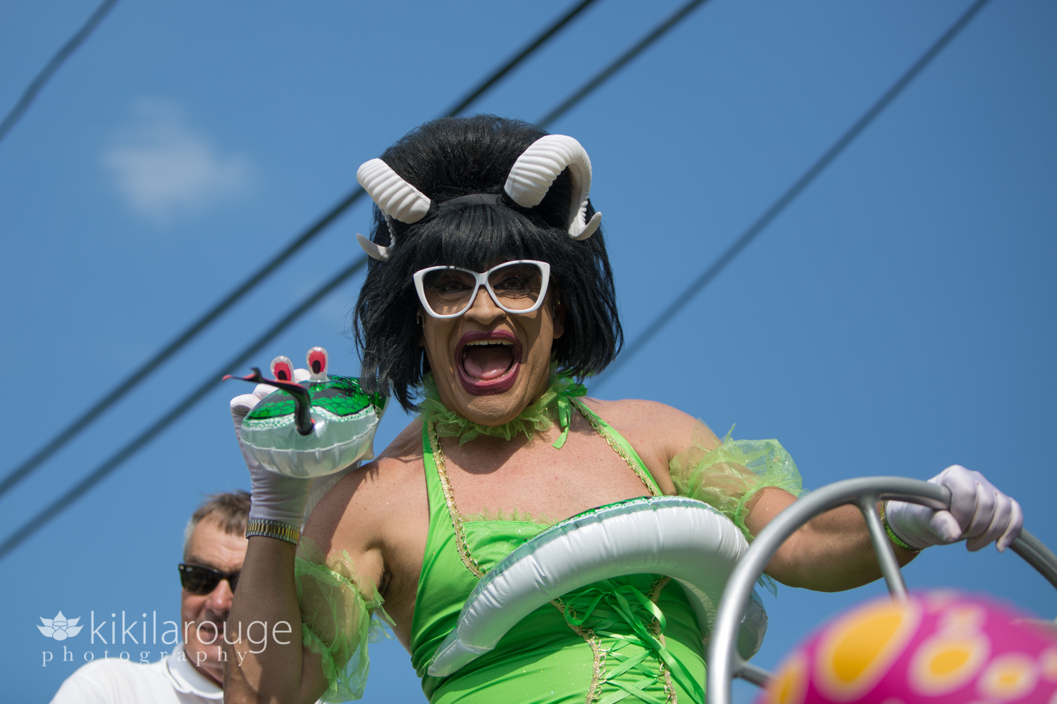 Drag queen with horns in green outfit