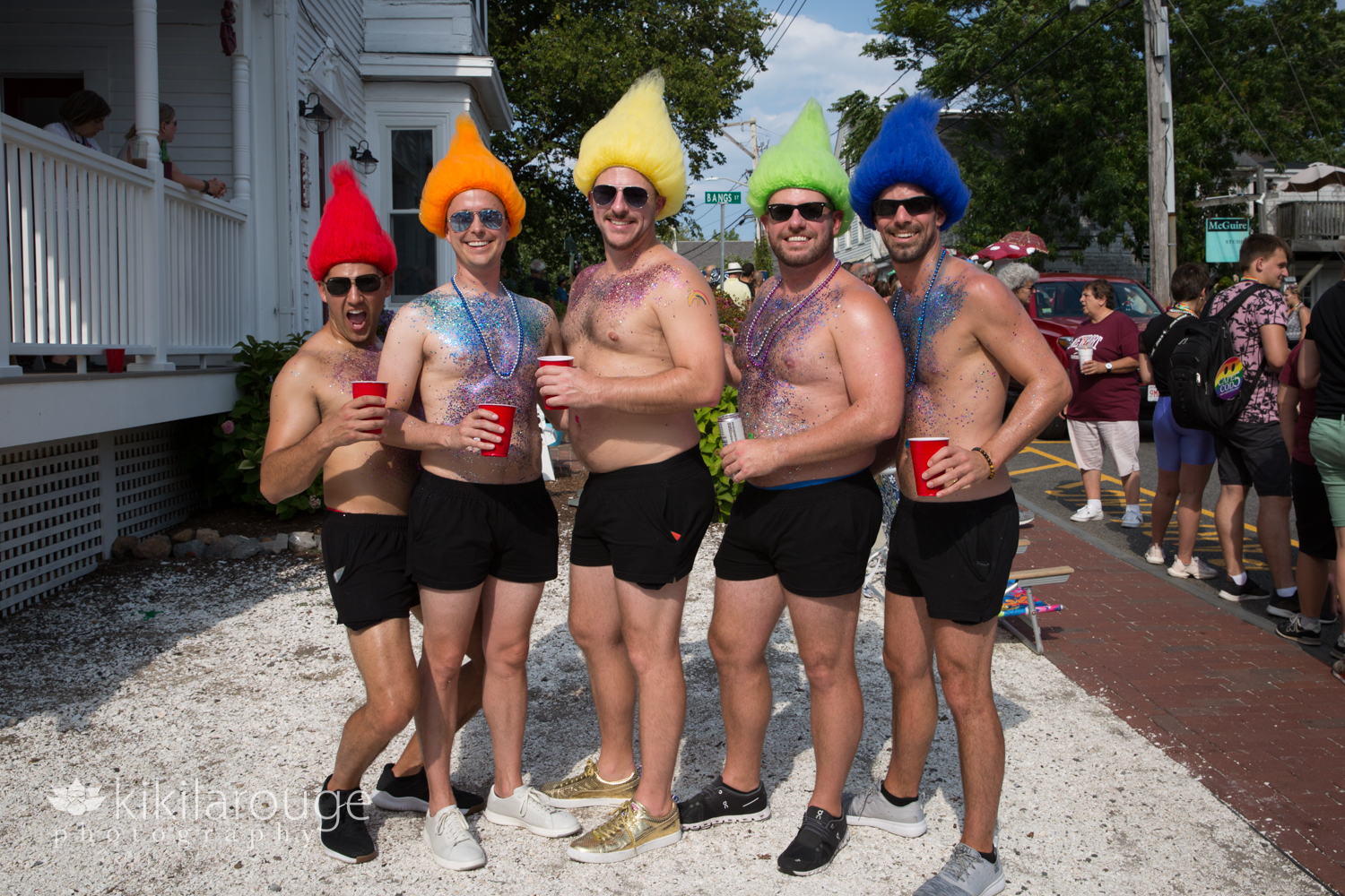 Five men with rainbow color wigs