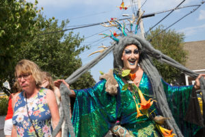 Smiling drag queen next to pouting woman