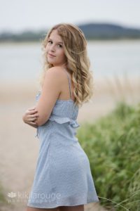 Girl looking back over shoulder with blu dress and blonde hair