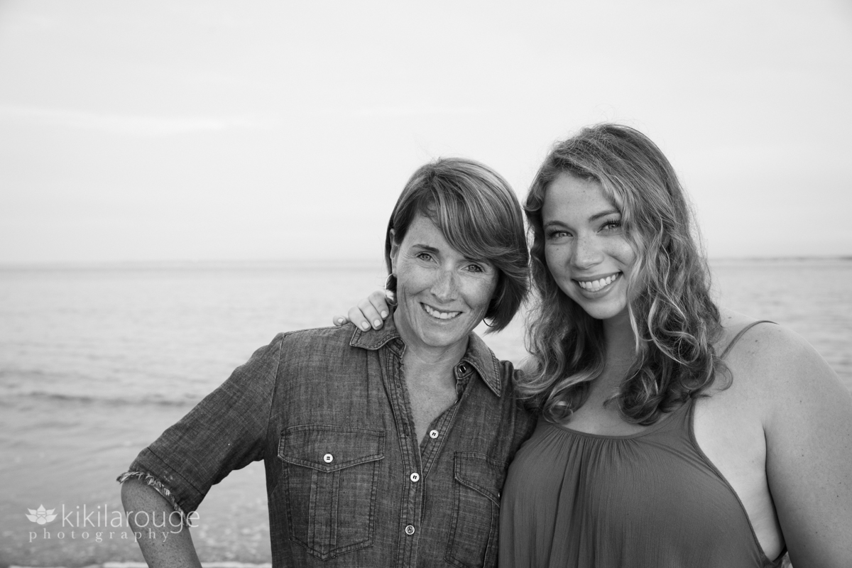 Mom and daughter portrait smiling at beach