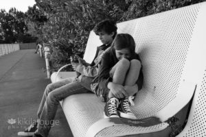 Boy and girl on metal bench by Puget Sound