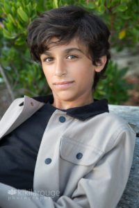 Portrait of boy with brown hair and sparkling brown eyes