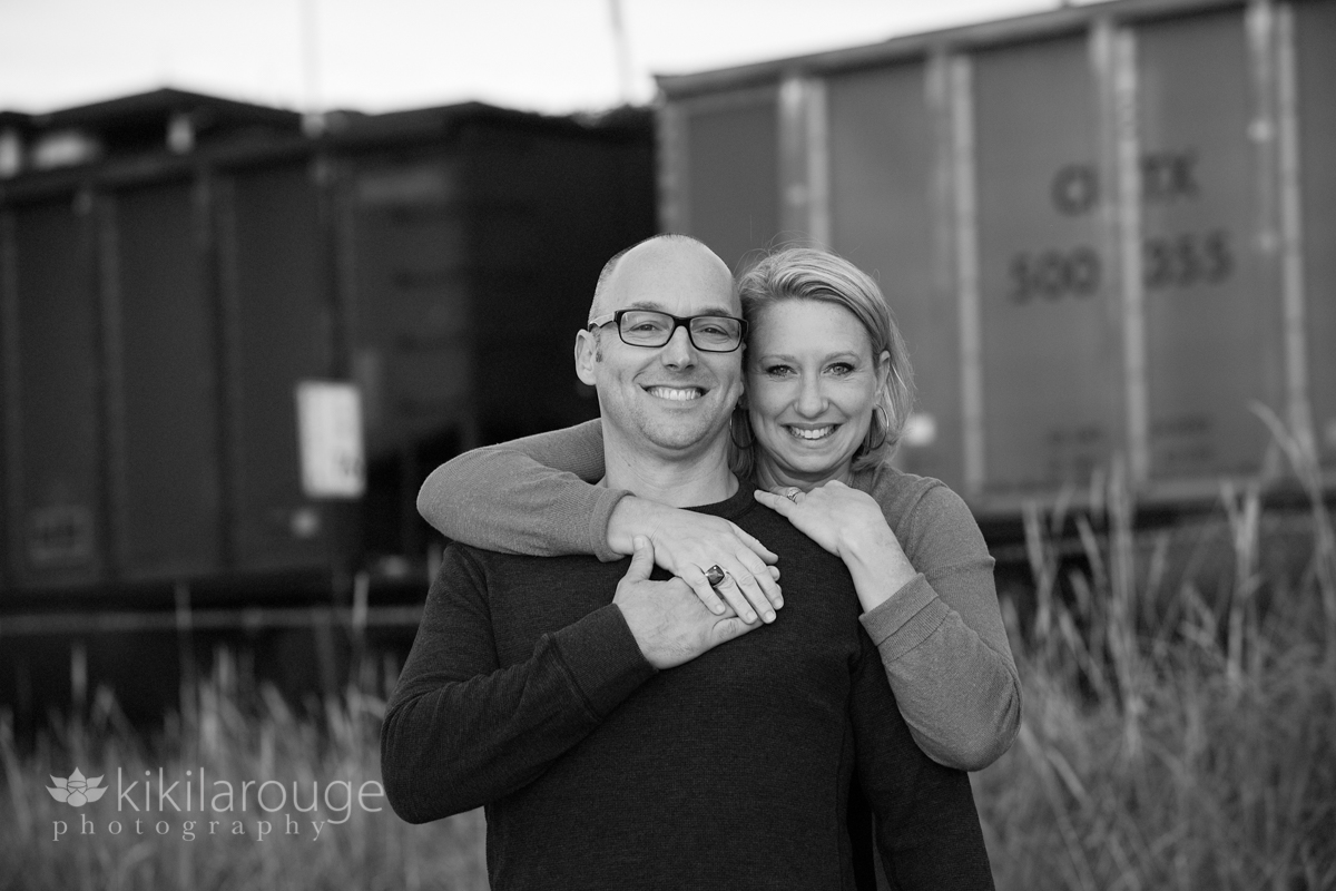 Couple at beach with train in background