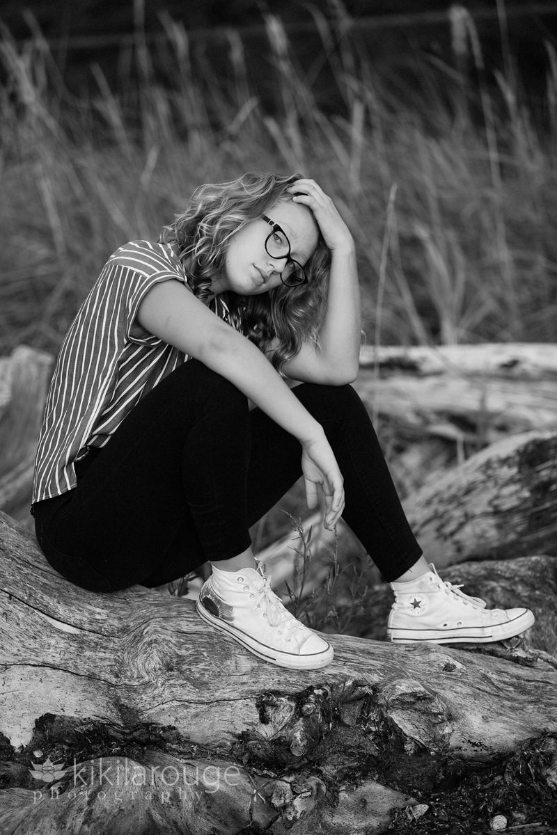 Teen girl on rock with sneakers