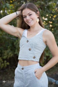 Girl in two piece striped outfit with long brown hair