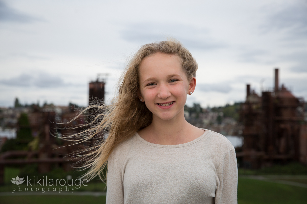 Girl on hill at Gas Works Park smiling wind blowing blonde hair