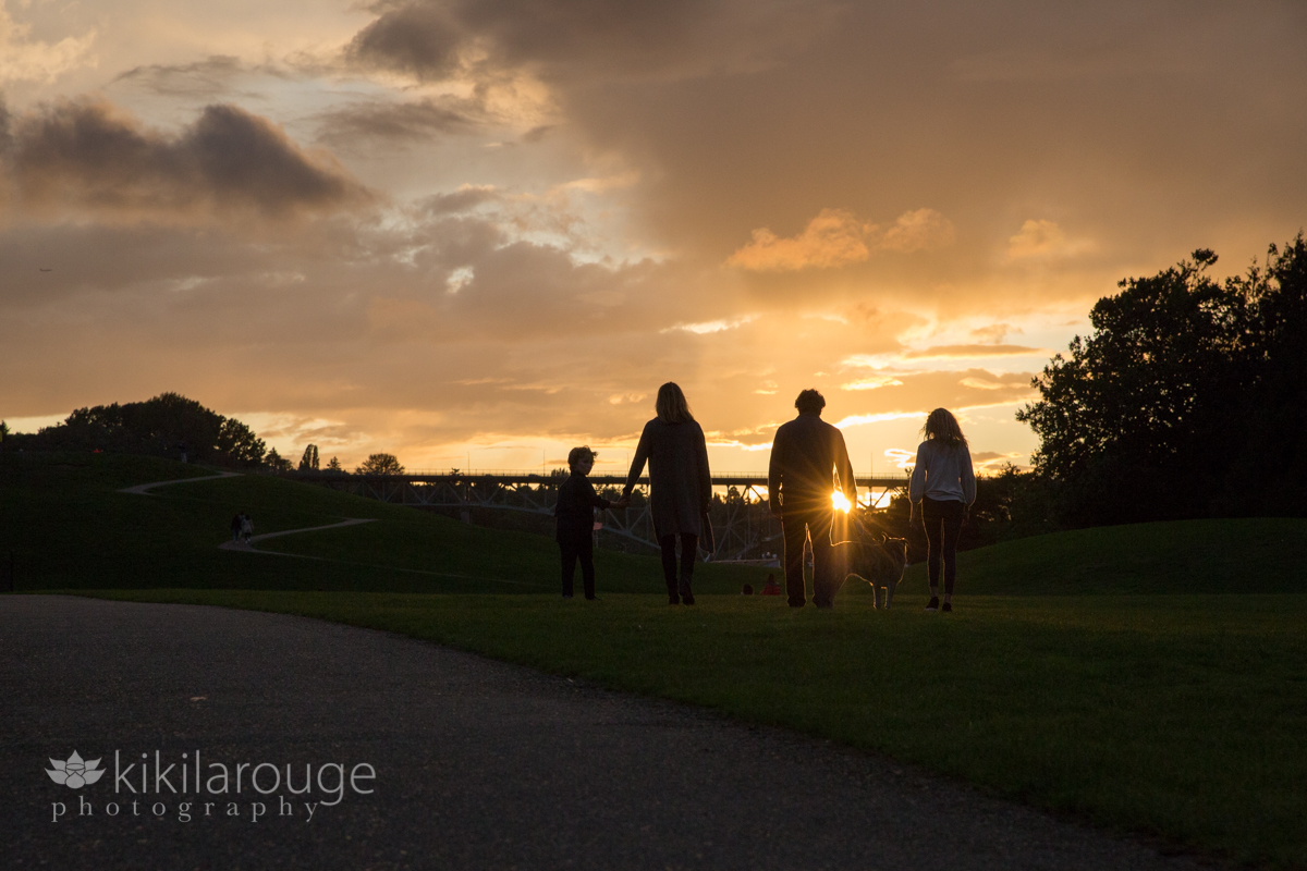 Silhouette of family walking into sunset