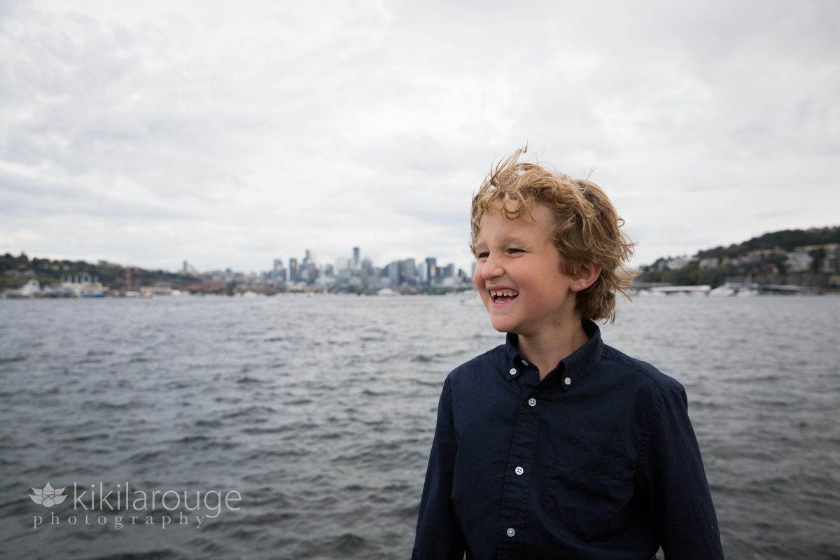 Boy boy shirt laughing with Seattle skyline and Lake Union