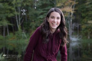 Young girl laughing by pond