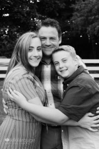 Daughter and son hugging Dad