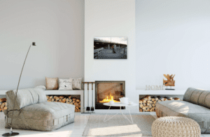 Portrait of couple with dog show on wall above fireplace