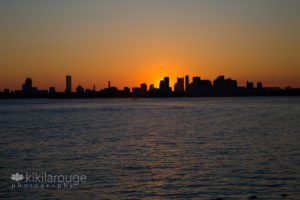 Bright Orange Sunset and silhouette of Boston Skyline from Harbor Islands
