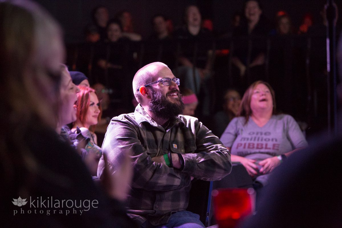 Audience at comedy show laughing