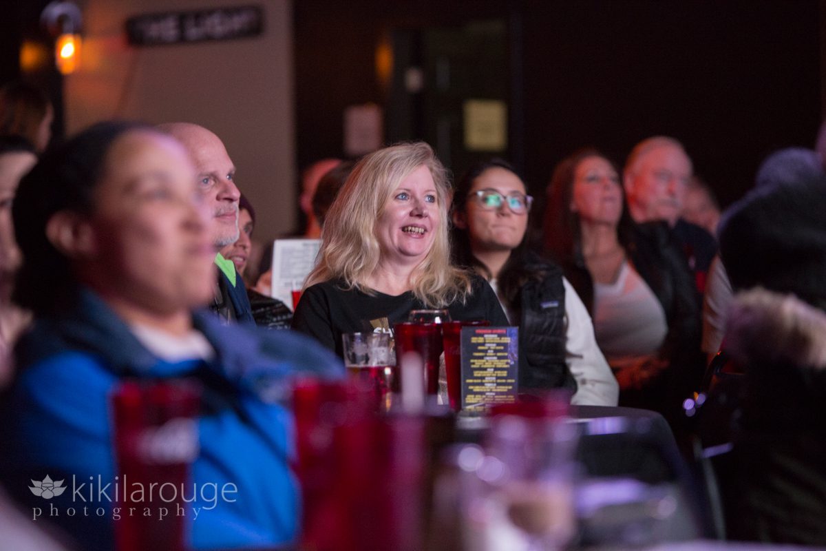 Audience at comedy show laughing