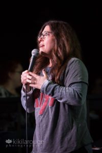 Stand up comic with KISS shirt on stage