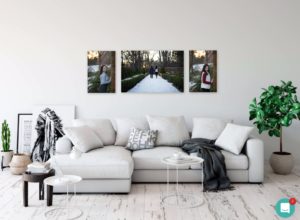 Room with a large sectional sofa showing three photographs on the wall