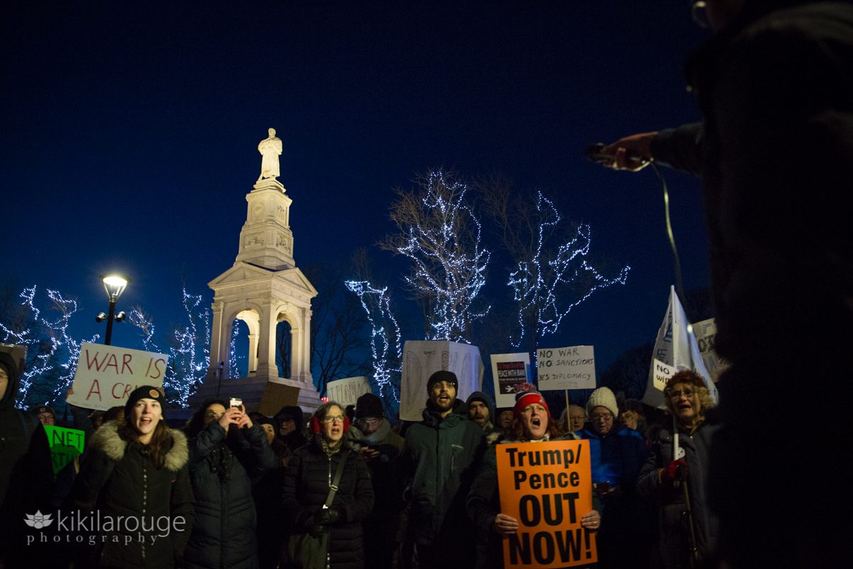 Protesters on Cambridge Mall in winter evening anitwar