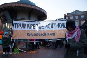 Harvard Square T station protest with anti Trump sign