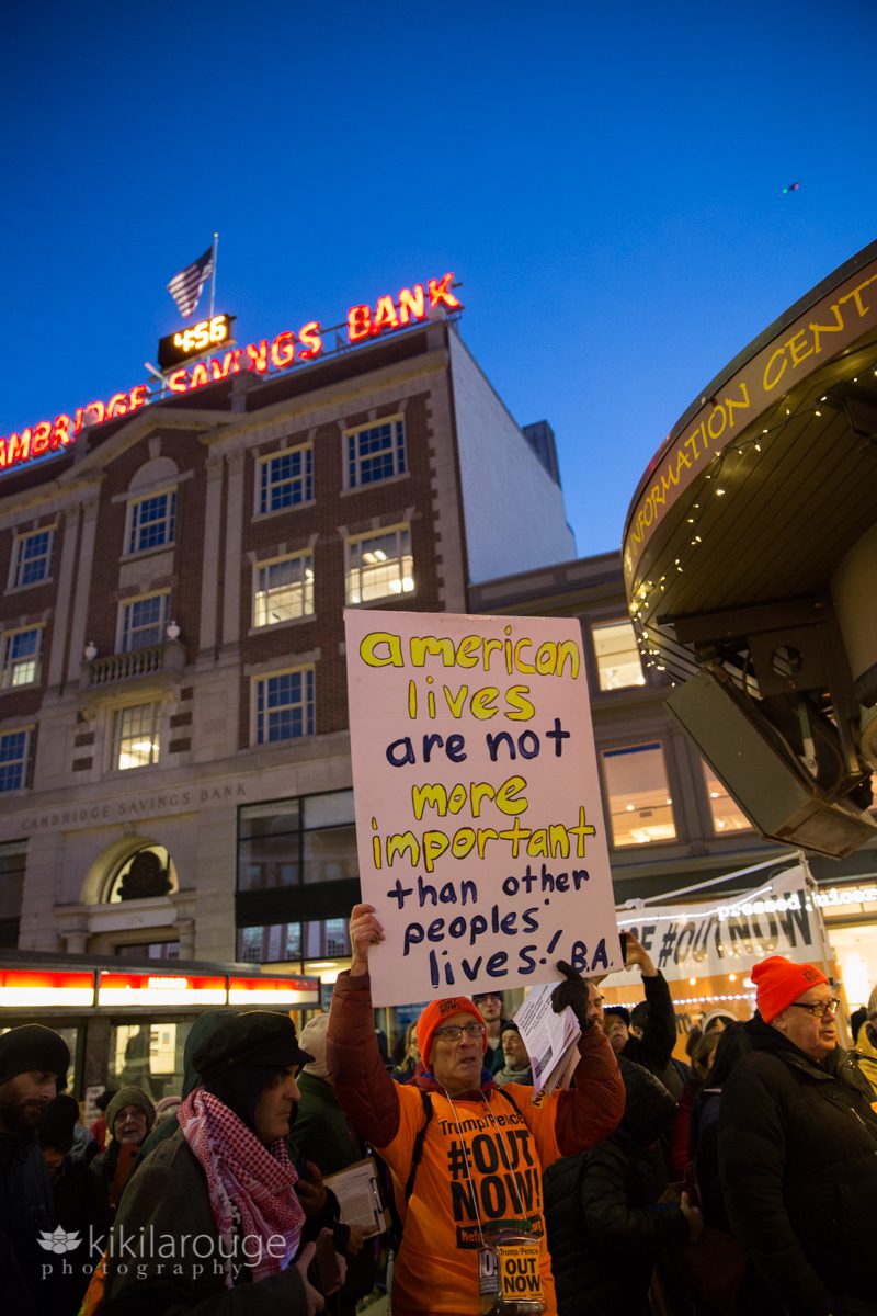 Blue hour Harvard Square at Cambridge Savings with protesters and signs