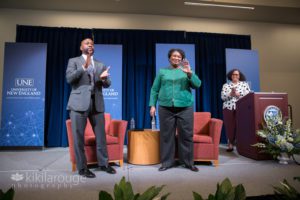 Stacey Abrams waving from stage at UNE to audience end of event