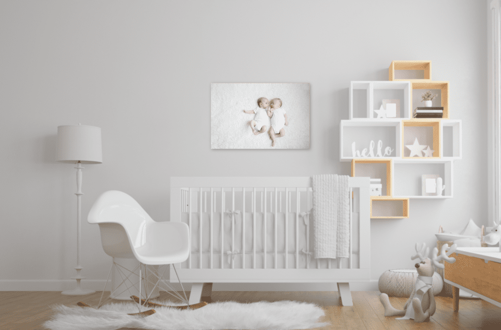 Baby nursery showing a newborn twin canvas on the wall