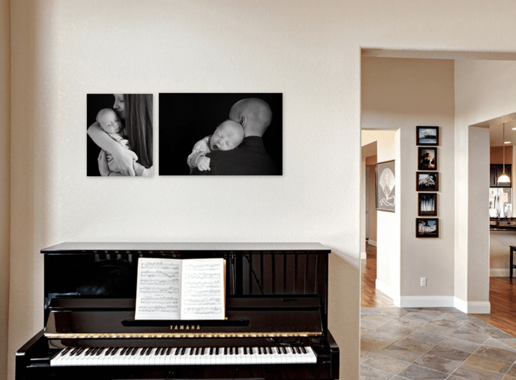 Photo of a room in a house with a piano and two portraits on wall of newborn babies