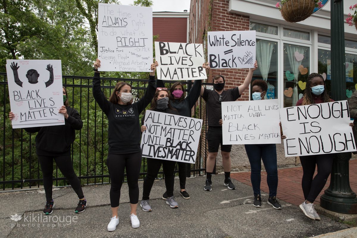 Group of young women holding signs at Black Lives Matter rally