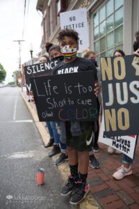 Young boy holding up sign at BLM rally